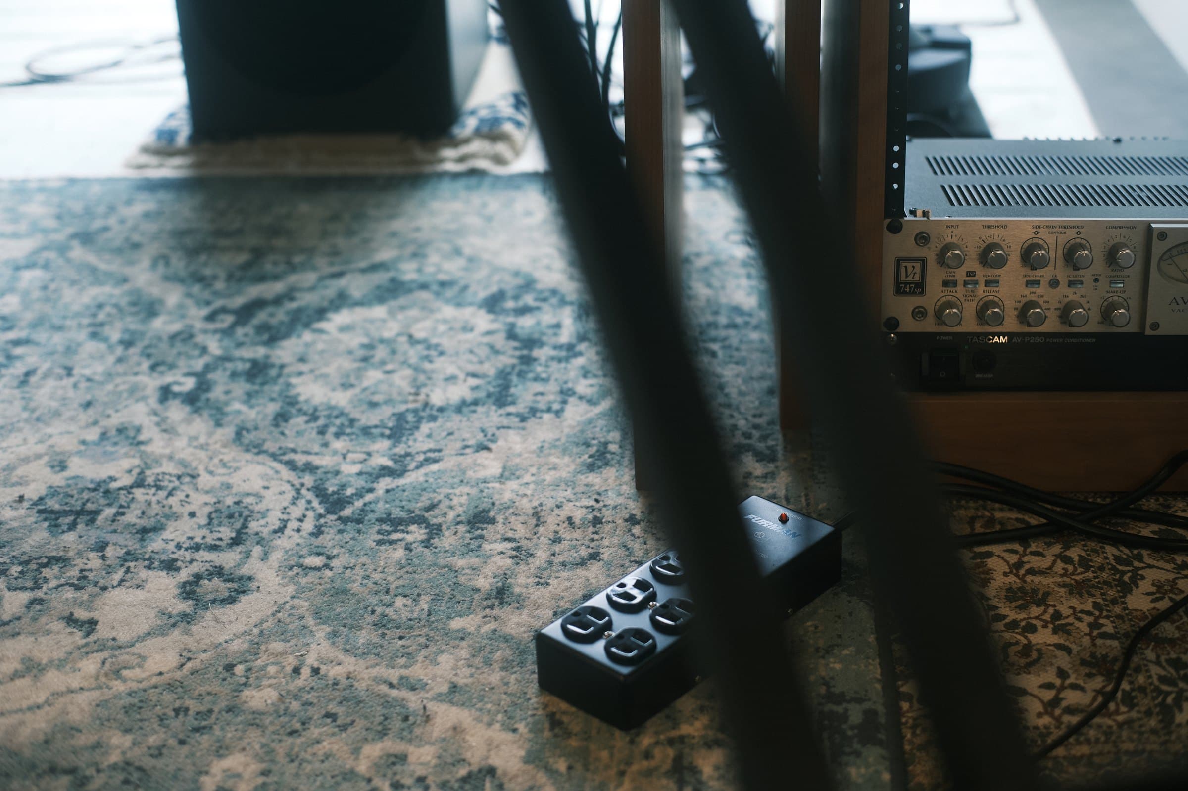 Outlet strip and rack-mounted gear on the studio floor