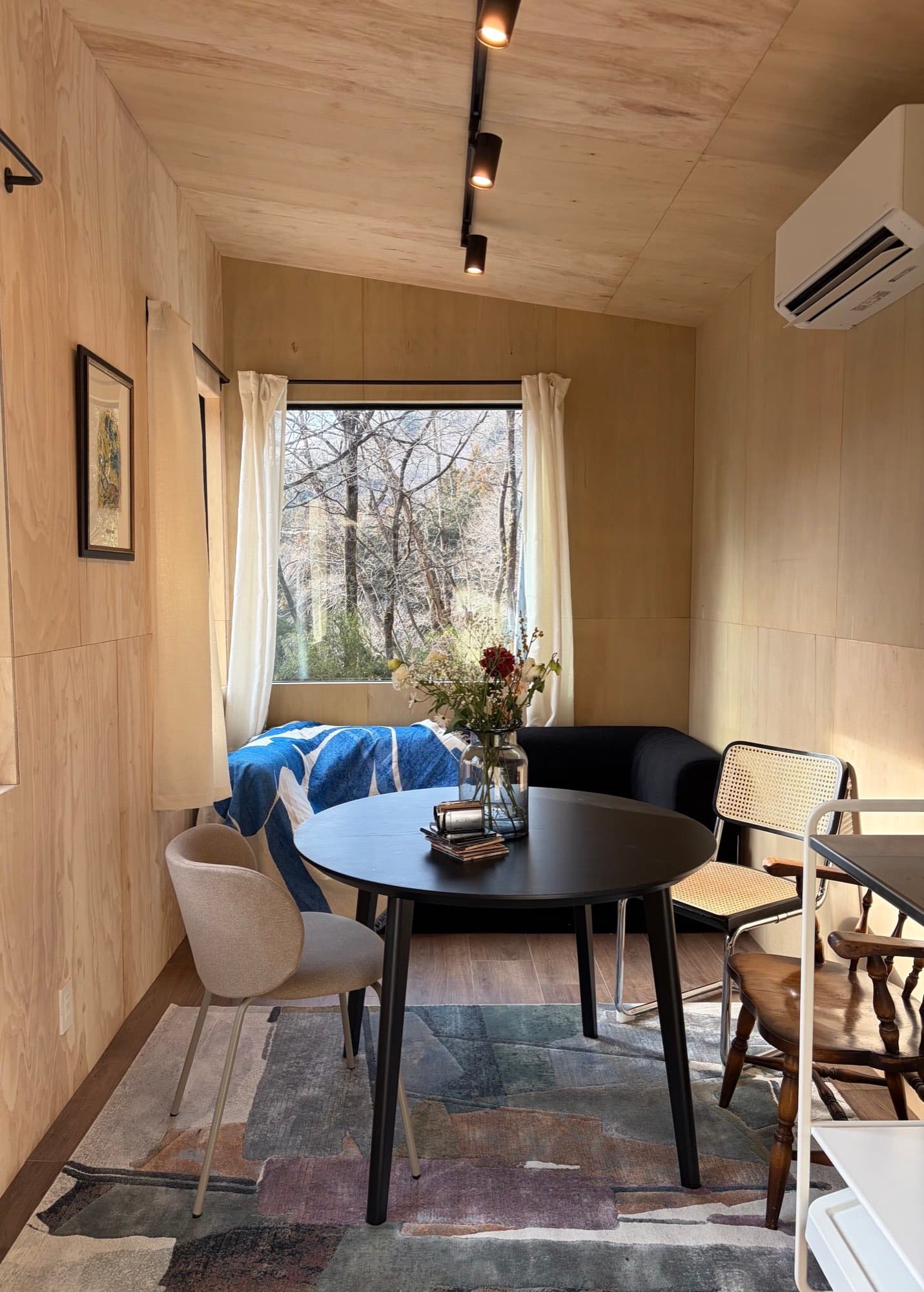 Lounge in the accommodation building with a sofa bed and dining table